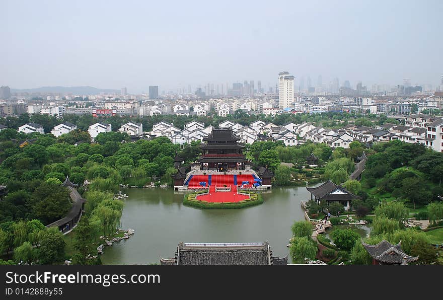 A Chinese ancient building in a park beside a lake. A Chinese ancient building in a park beside a lake.