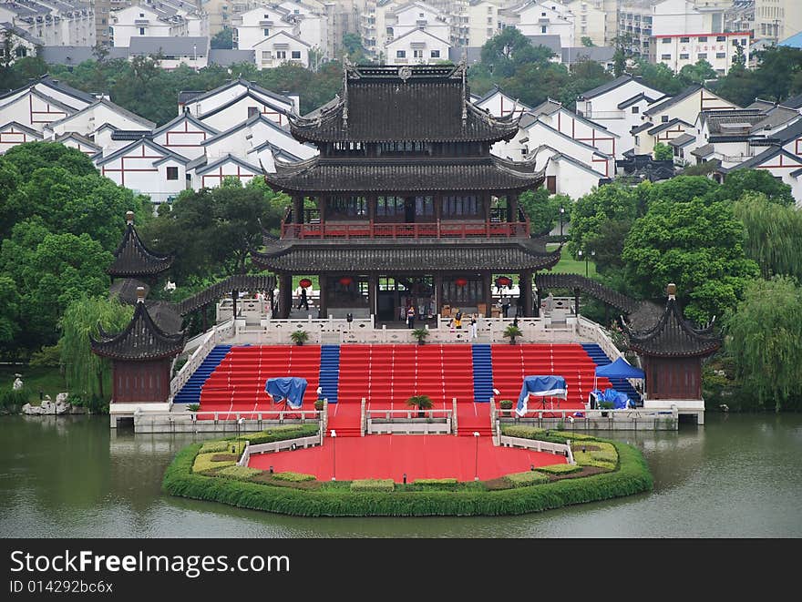 A Chinese ancient building in a park beside a lake. A Chinese ancient building in a park beside a lake.