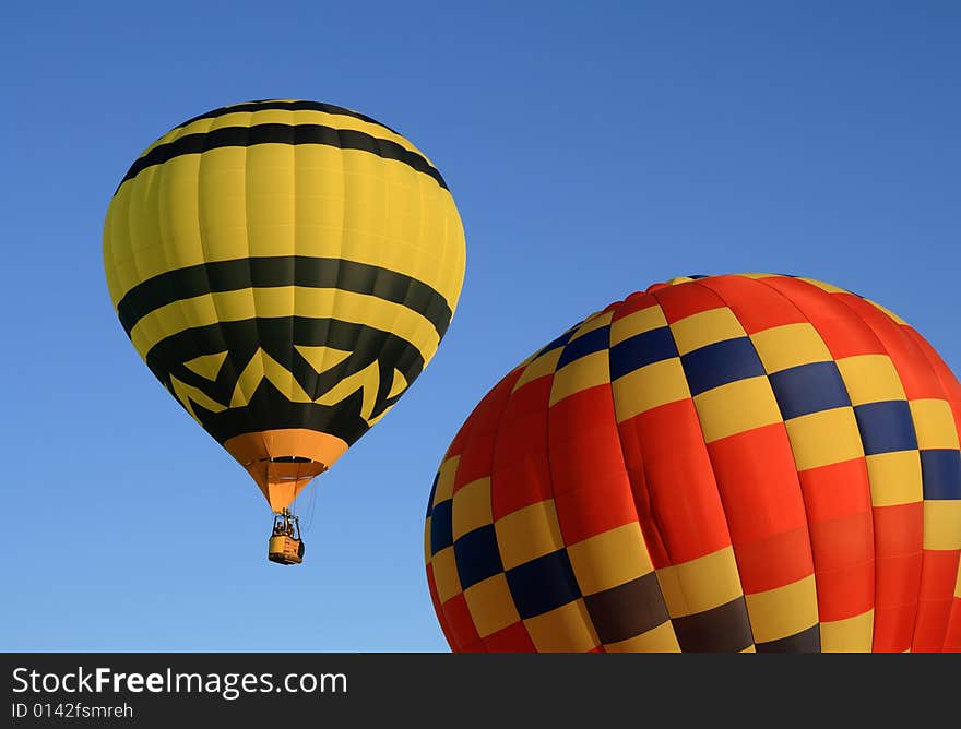 Yellow and red hot air balloons in the blue sky. Yellow and red hot air balloons in the blue sky.