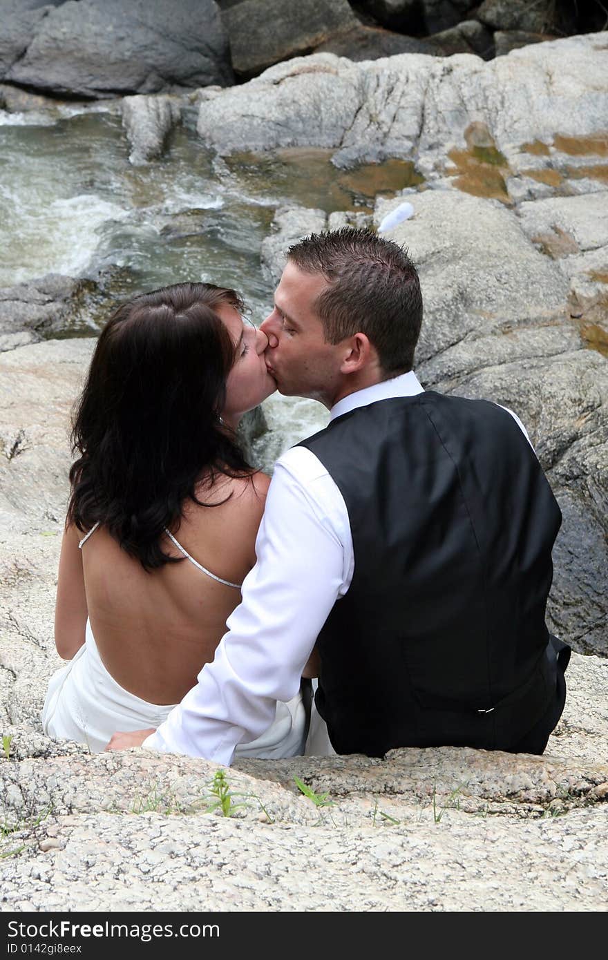 Happy bride and groom on top of a mountain.