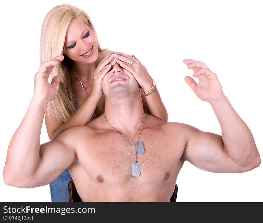 Woman covers man's eyes with hands, isolated on white background