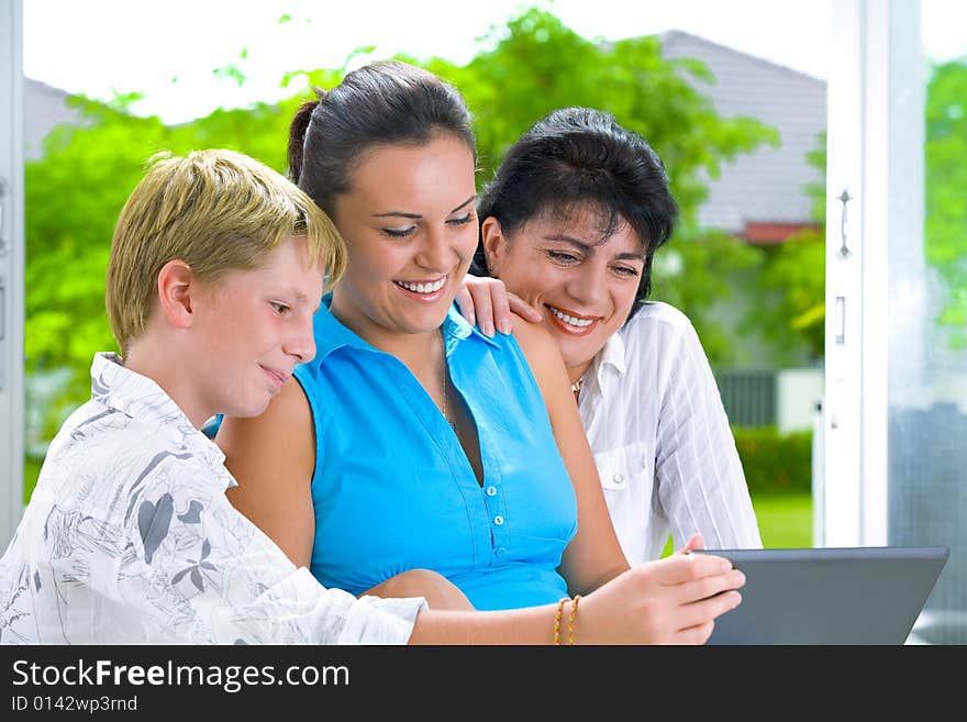 Portrait of happy family getting busy with laptop. Portrait of happy family getting busy with laptop