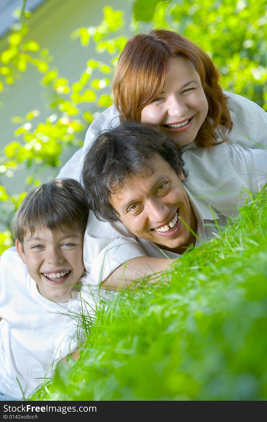 Portrait of young happy family in summer environment