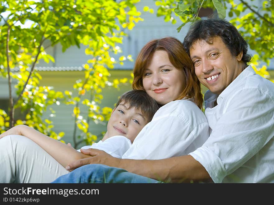 Portrait of young happy family in summer environment. Portrait of young happy family in summer environment