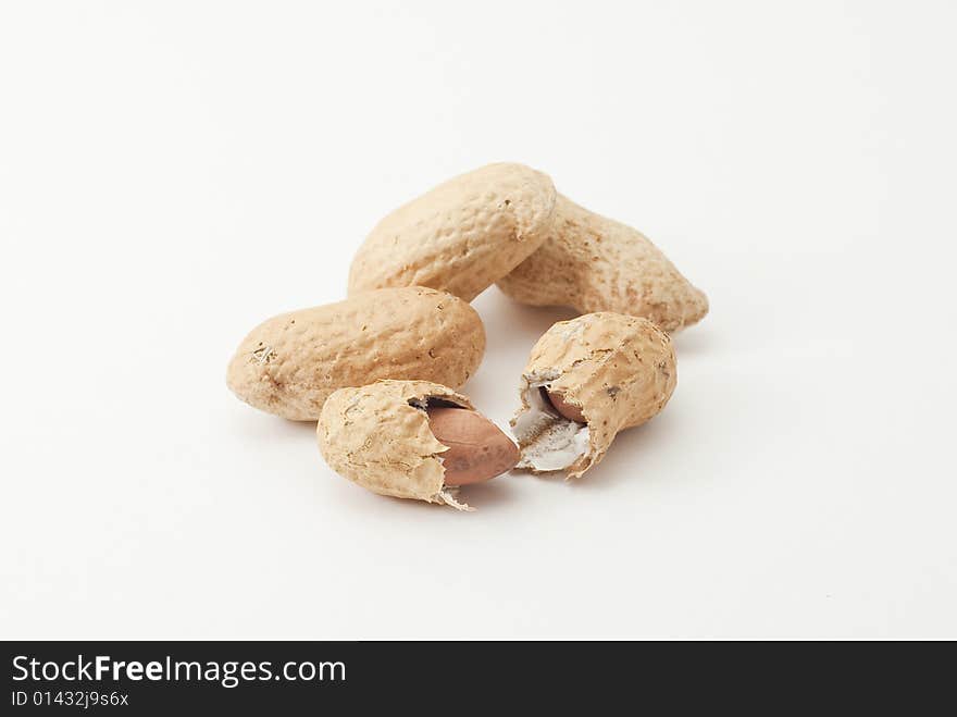 Group of peanuts; one of them is cracked. Group of peanuts; one of them is cracked.