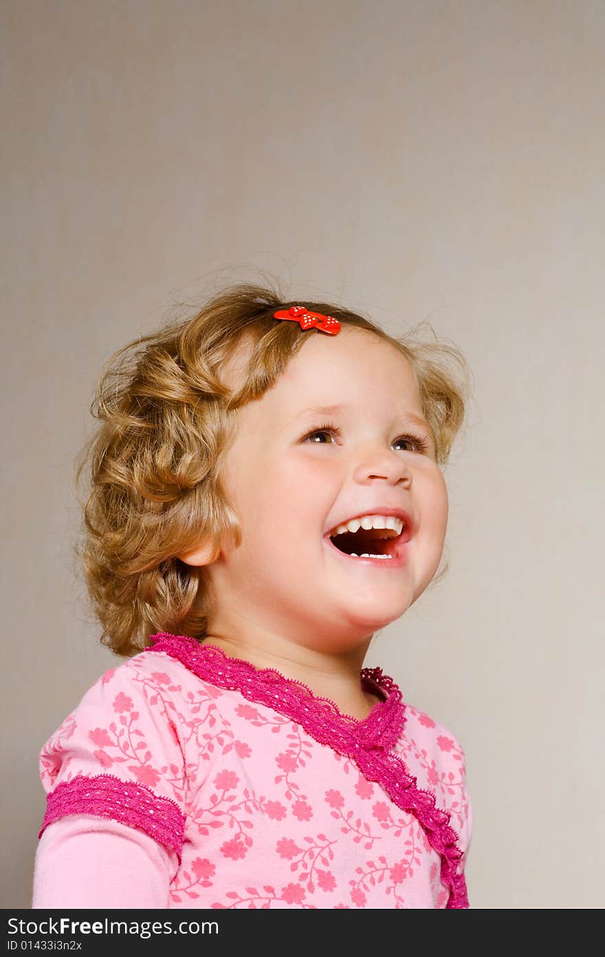 Small pretty laughing girl in rose dress. Small pretty laughing girl in rose dress