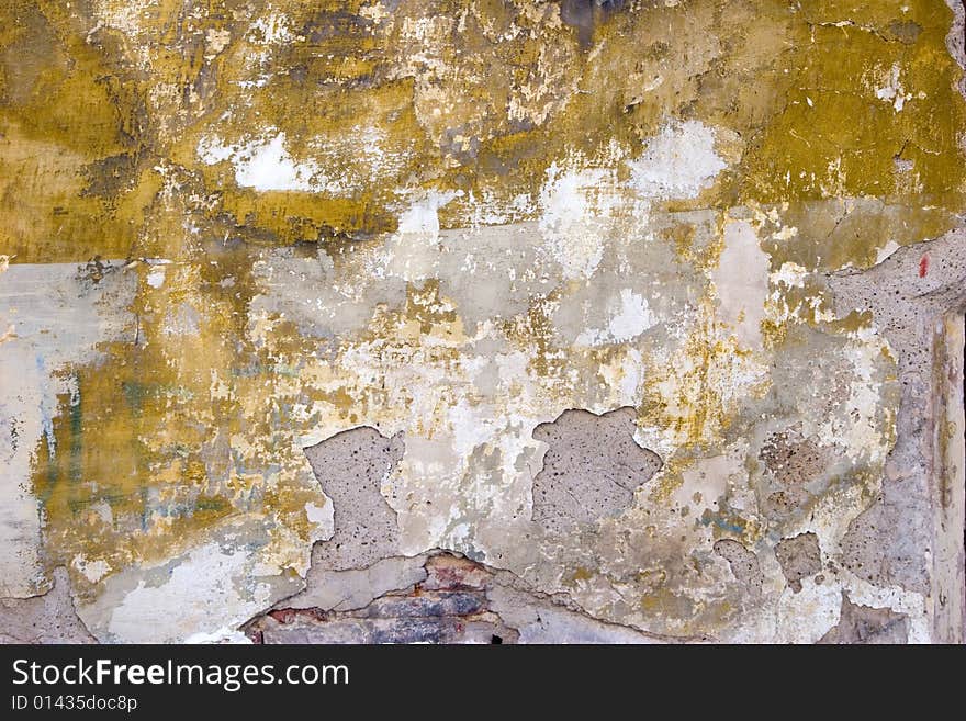 Closeup of grey old wall with peeled stucco and stains. Closeup of grey old wall with peeled stucco and stains