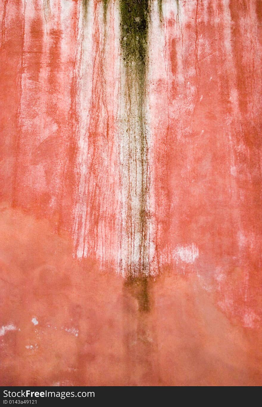 Closeup of red-brown old wall with peeled stucco and stains. Closeup of red-brown old wall with peeled stucco and stains