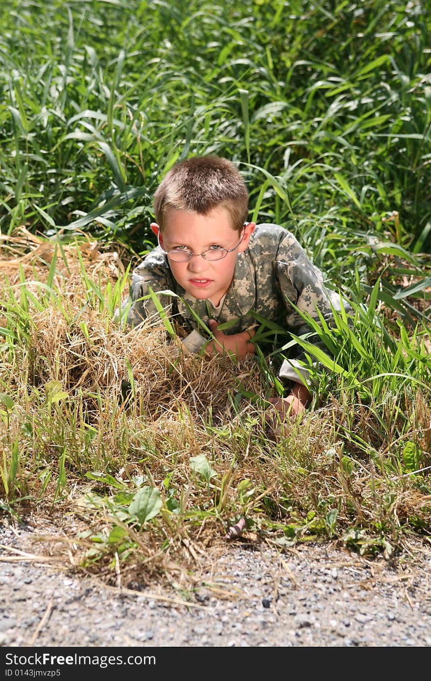 Young child in cammoflage crawling