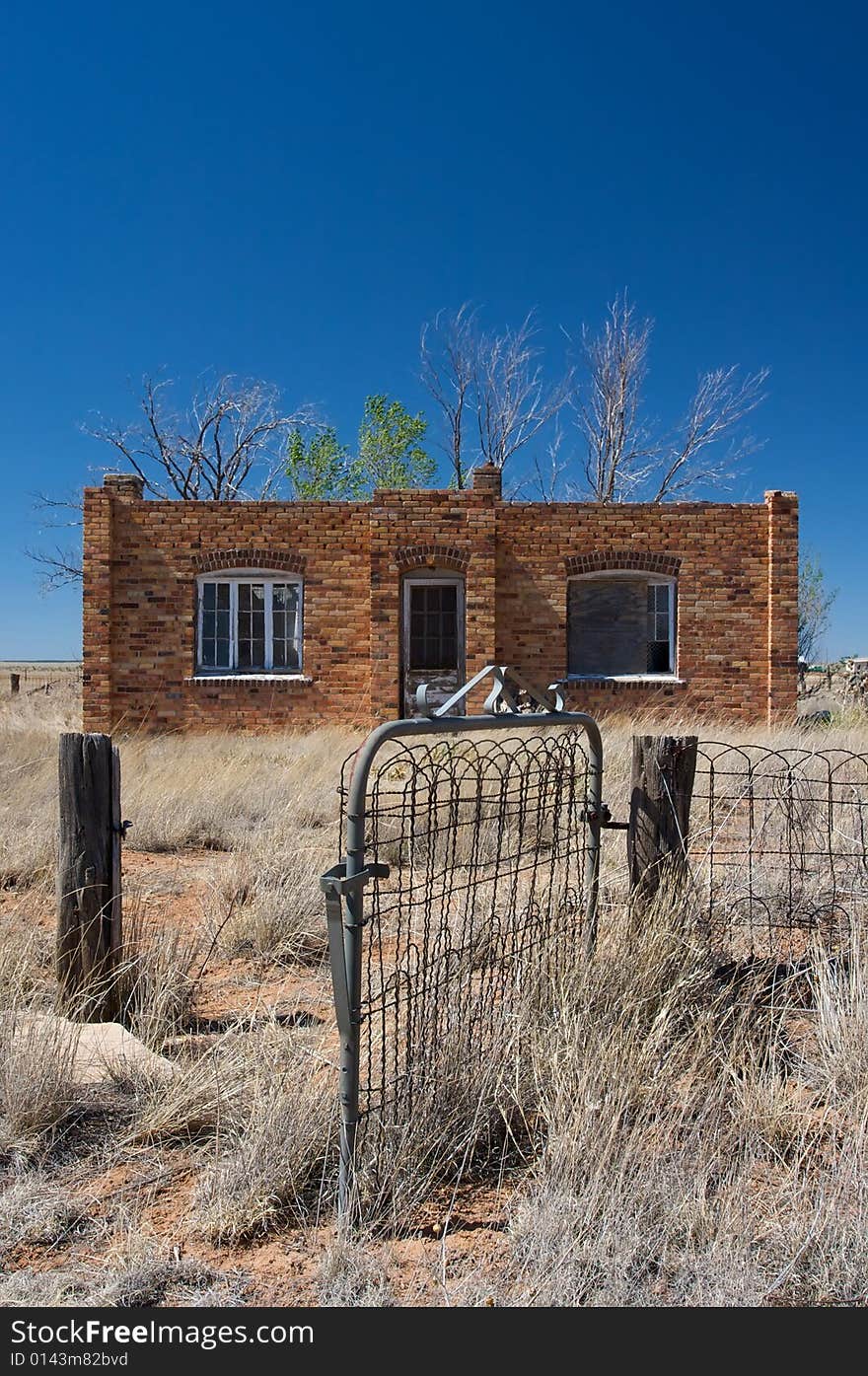 An image of a rustic brick house in the desert