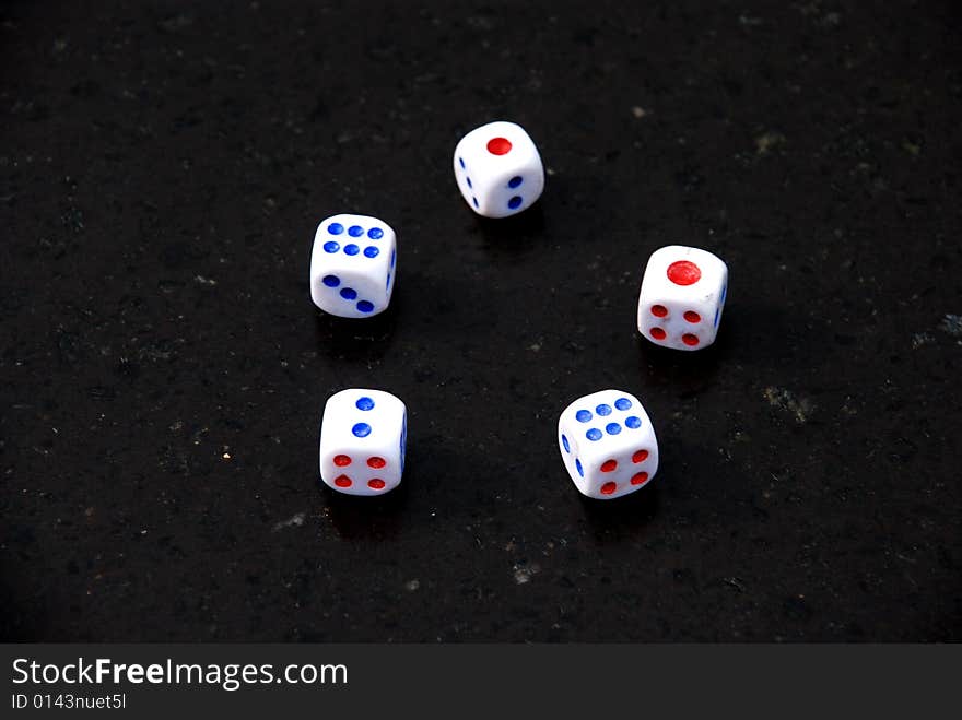 Five Dices with red and blue dots on the black background. Five Dices with red and blue dots on the black background.