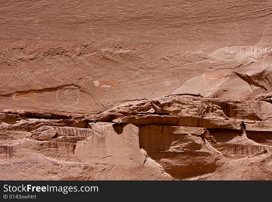 An image of carvings and ancient art on canyon walls