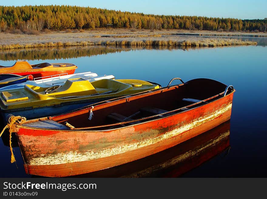 Ferreous boat in the lake in the early morning at sunrise. Ferreous boat in the lake in the early morning at sunrise