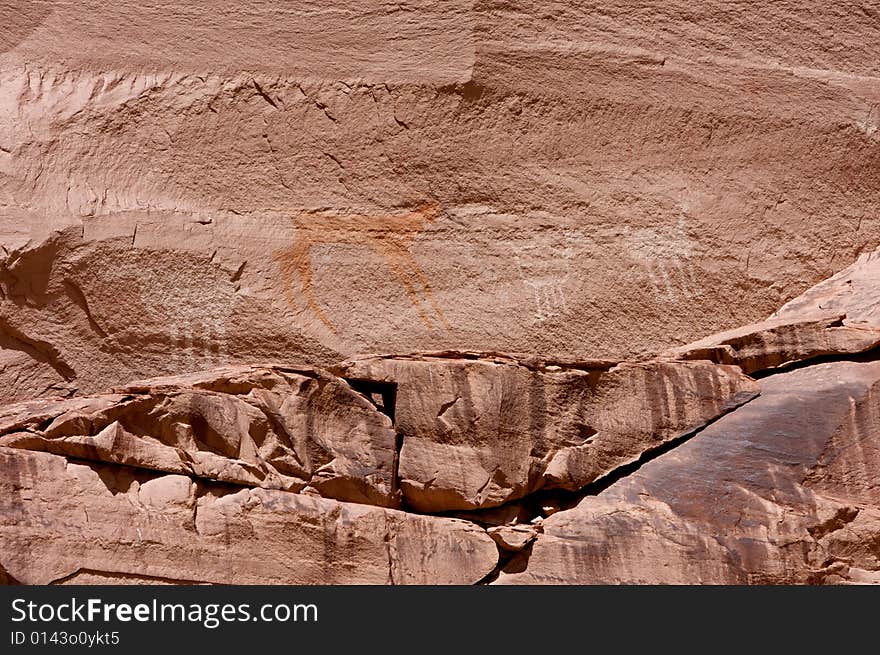 An image of carvings and ancient art on canyon walls