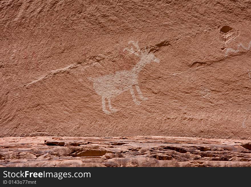 An image of carvings and ancient art on canyon walls