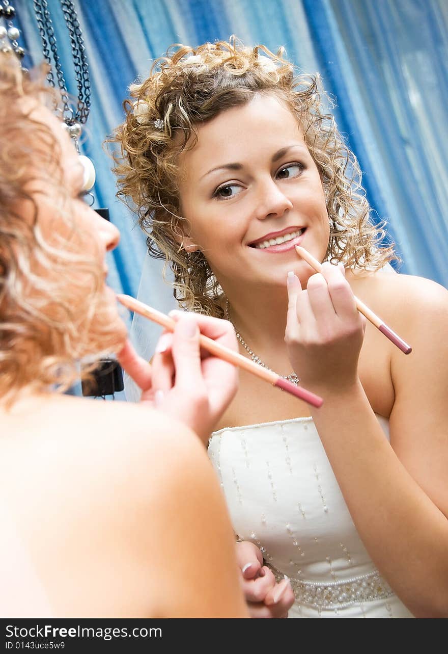 Pretty bride near the mirror