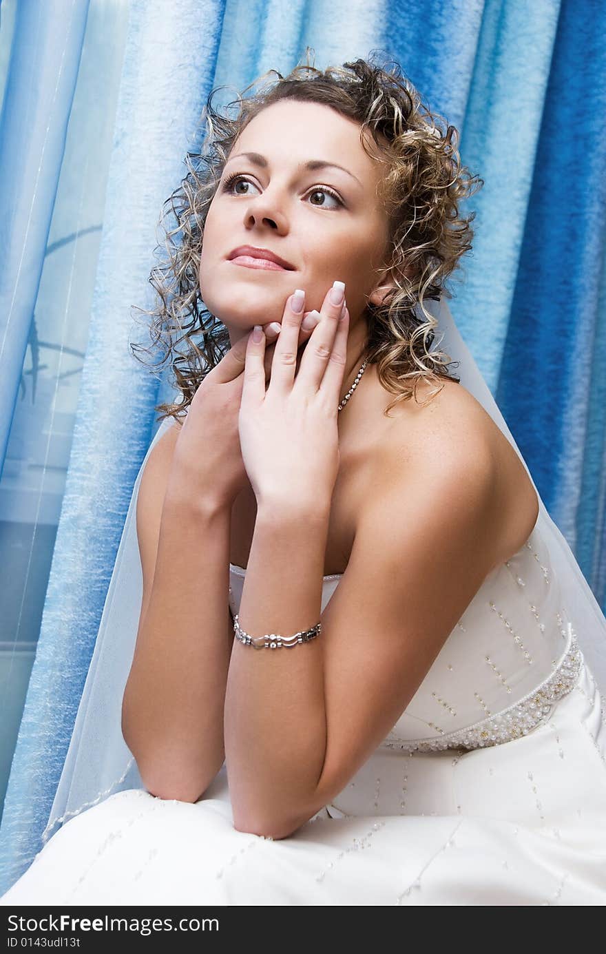 Pretty young bride sitting on the bed. Pretty young bride sitting on the bed