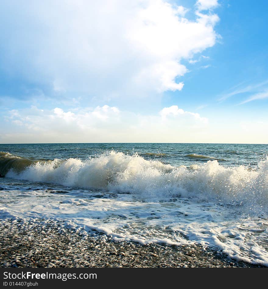 Wave on sea beach under year blue sky and cloud