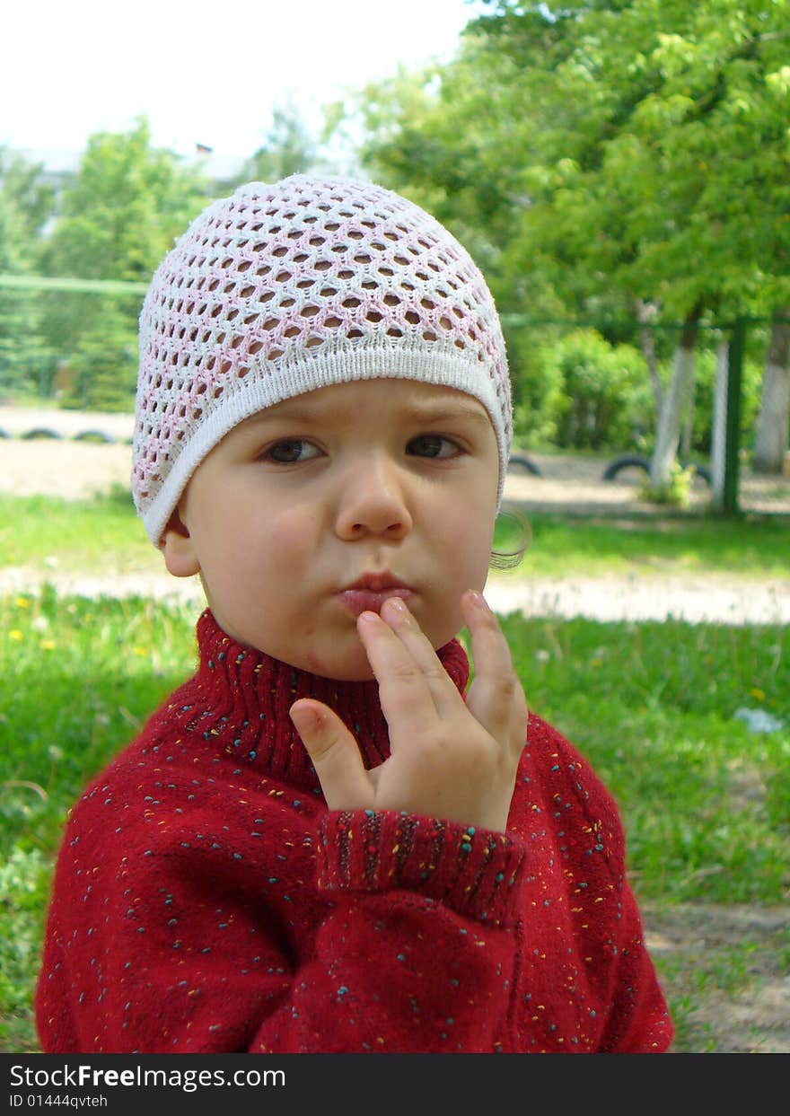 The girl eats in the street. The girl eats in the street