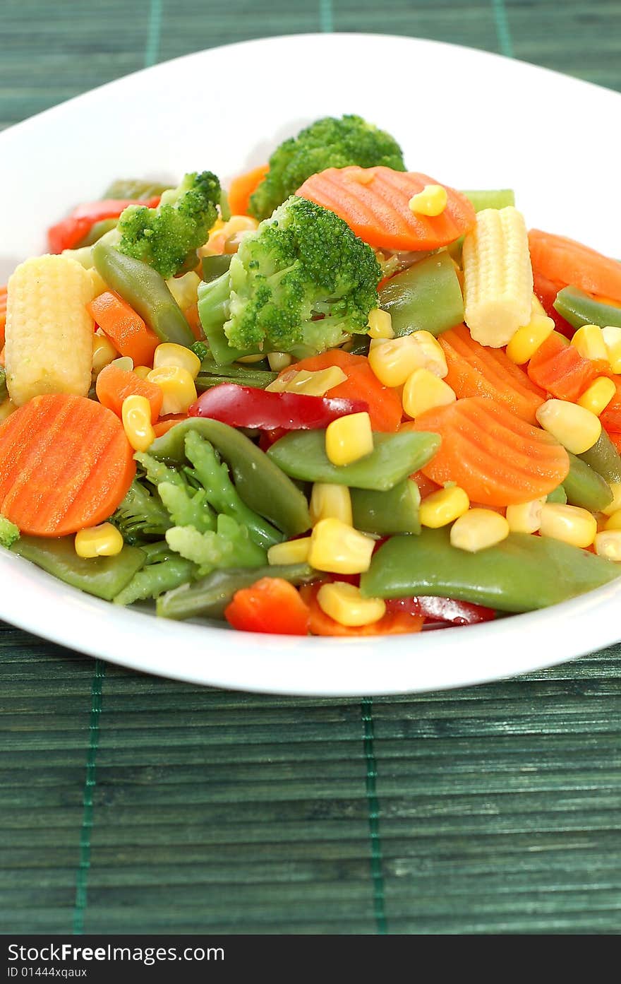 Cooked carrots sweet corn and broccoli on plate. Cooked carrots sweet corn and broccoli on plate