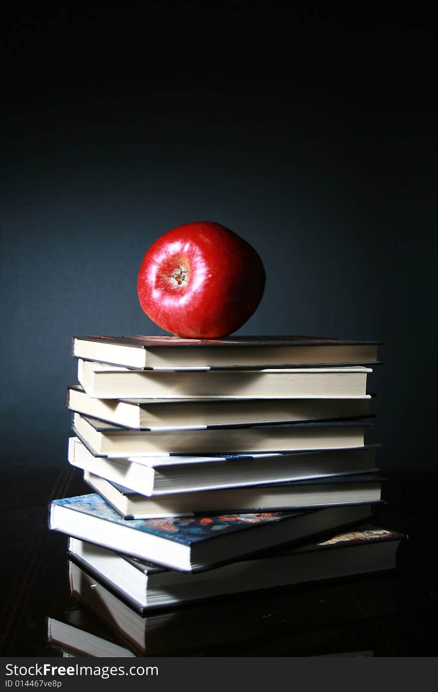 Books and red apple. School concept.