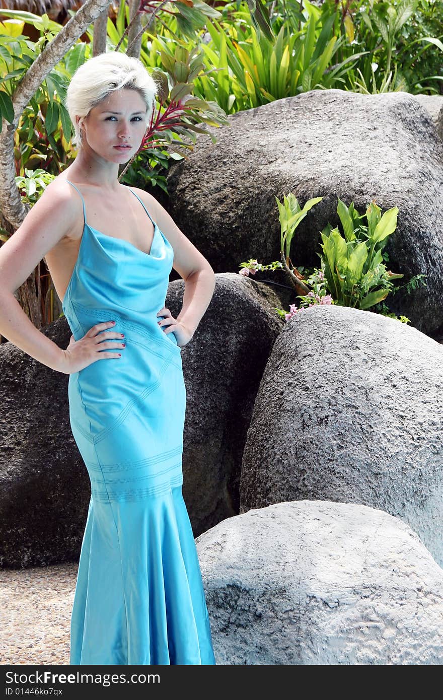 Gorgeous blond woman wearing a blue evening gown.