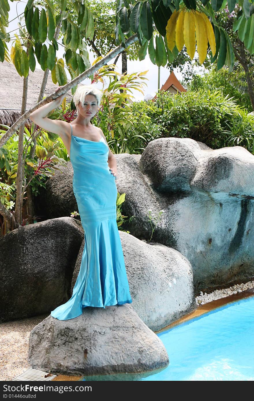 Gorgeous blond woman wearing a blue evening gown.