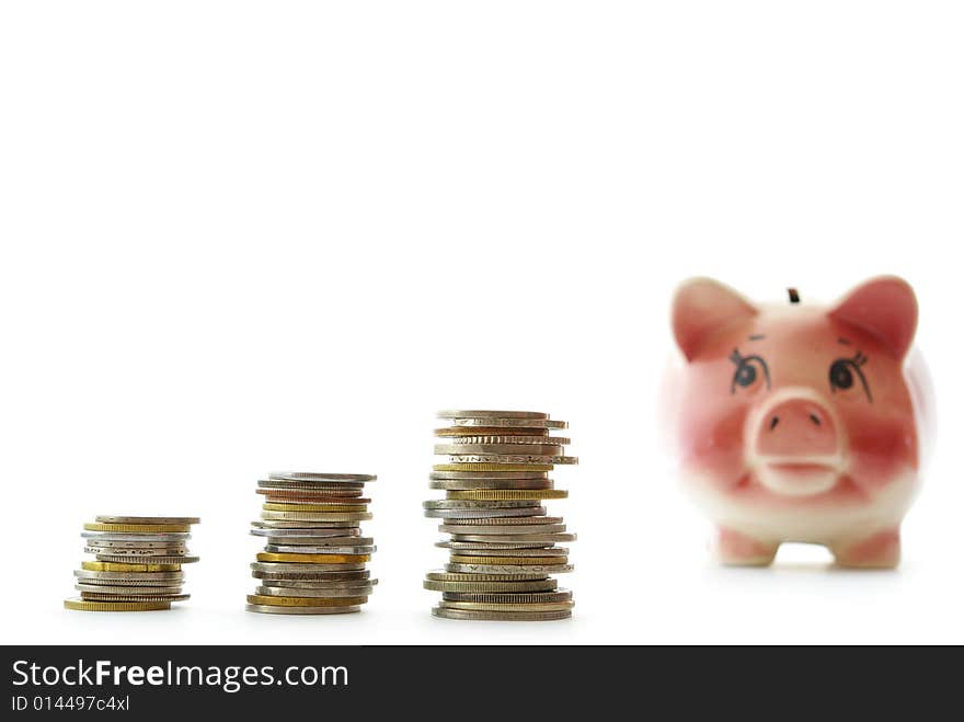 Pink piggy bank  isolated on white background with coins. Pink piggy bank  isolated on white background with coins