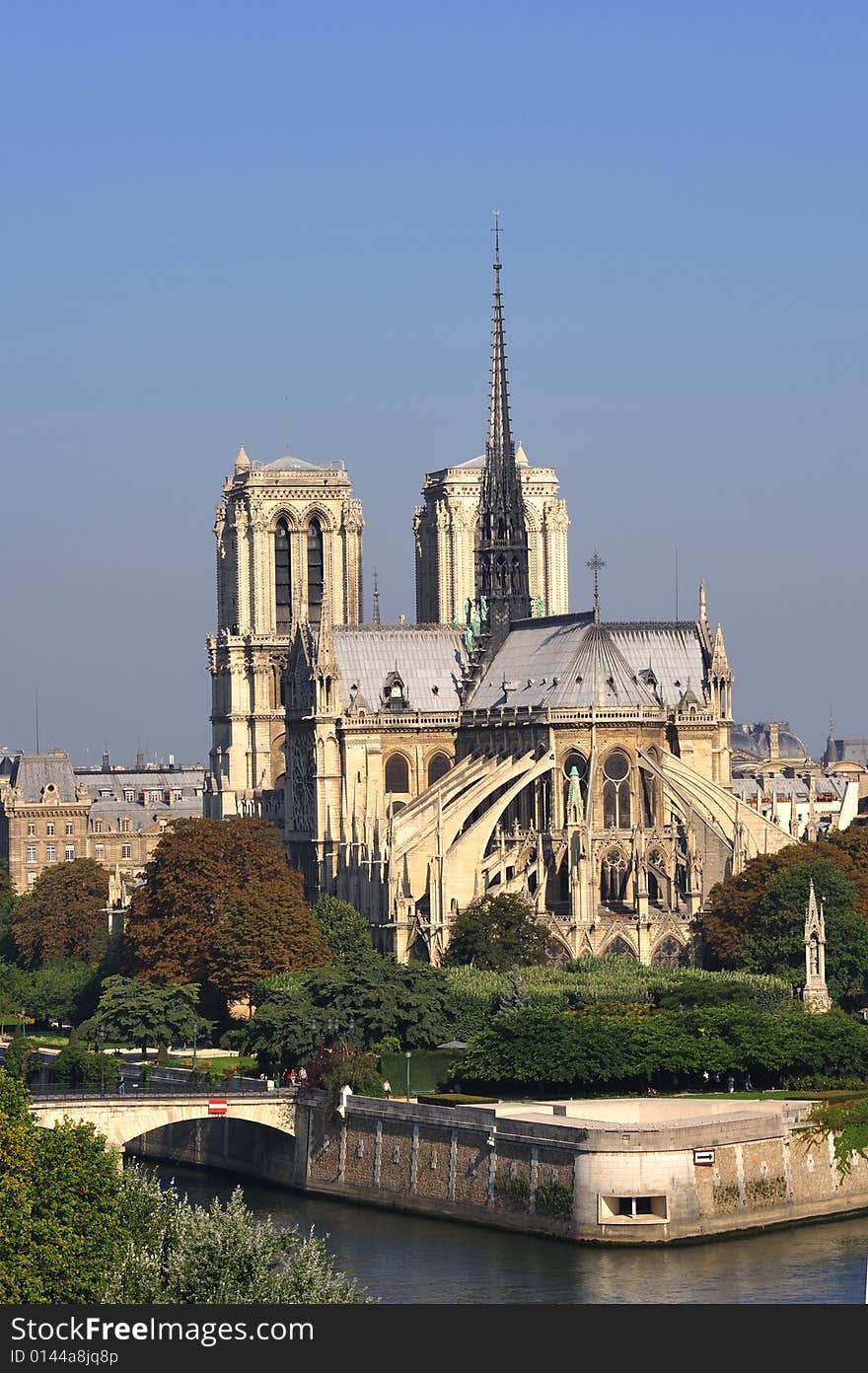 France, Paris: nice city view from the quai of the seine river; blue sky, green trees and the Seine river for this view of Paris with Notre Dame cathedral on the background. France, Paris: nice city view from the quai of the seine river; blue sky, green trees and the Seine river for this view of Paris with Notre Dame cathedral on the background