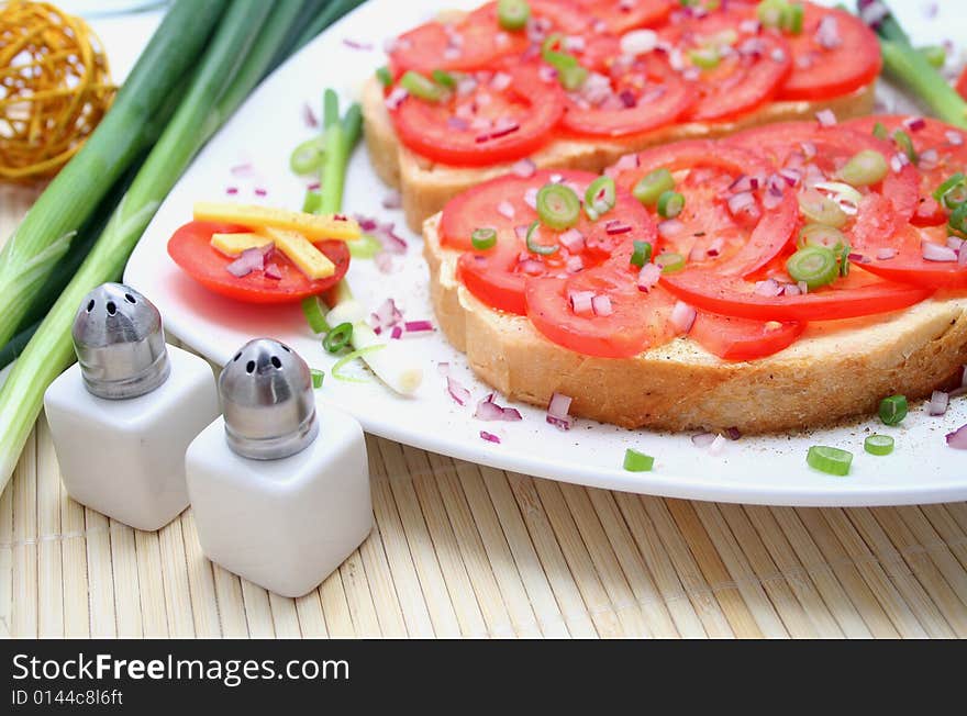 A breakfast of fresh bread and tomatoes