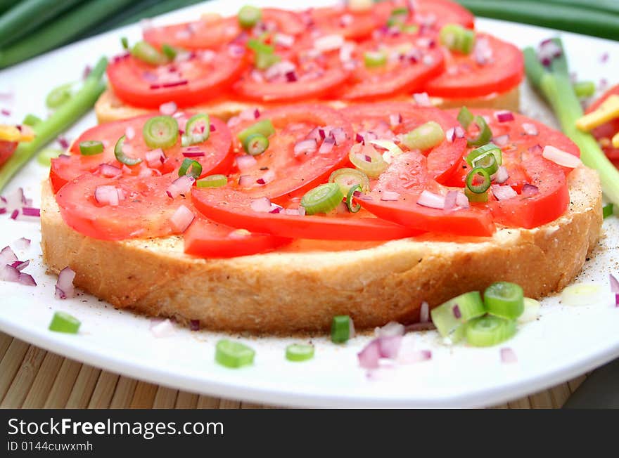 A breakfast of fresh bread and tomatoes