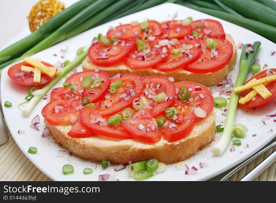 A breakfast of fresh bread and tomatoes