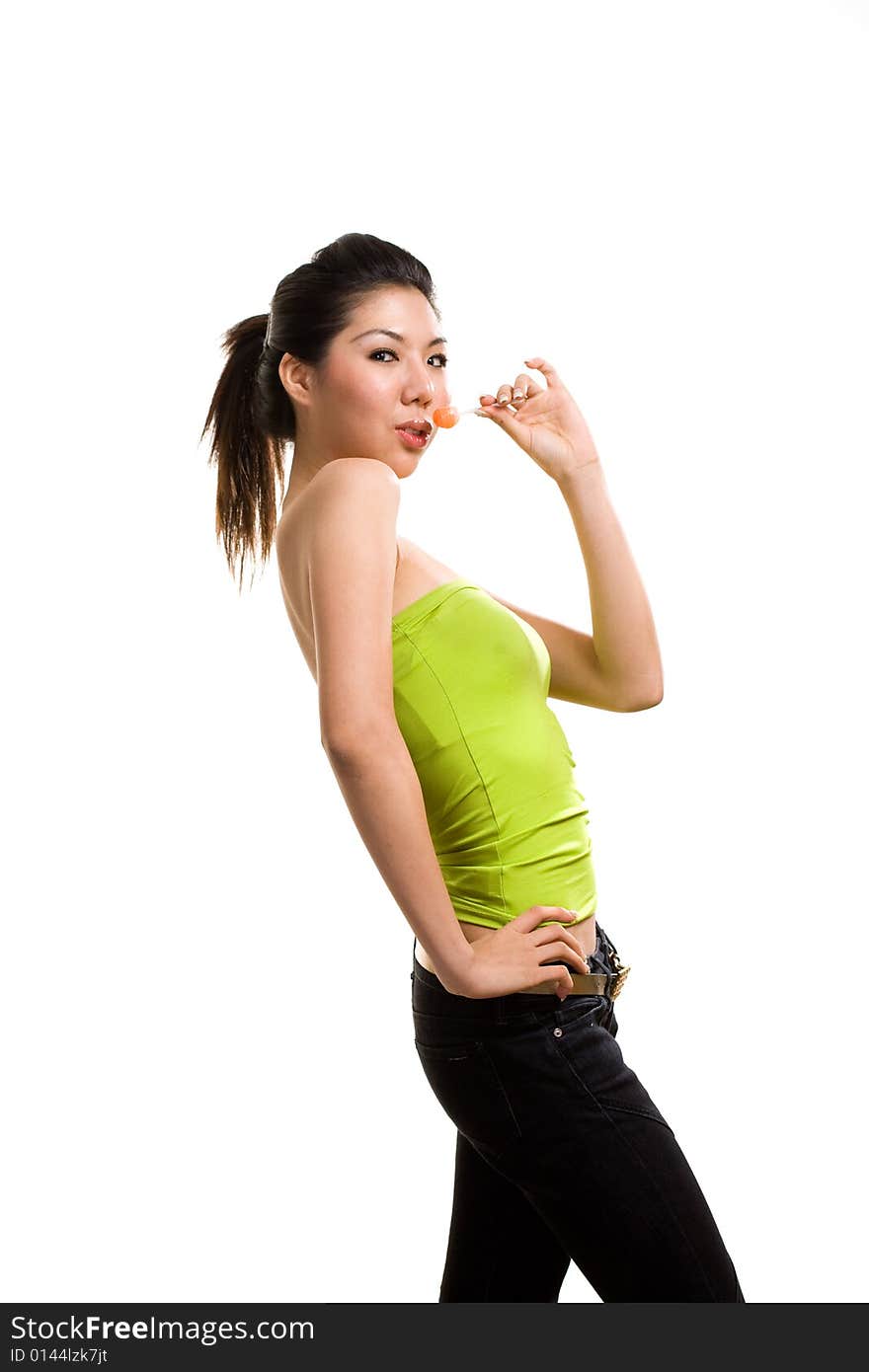 Young asian woman having fun eating lollipop. Young asian woman having fun eating lollipop