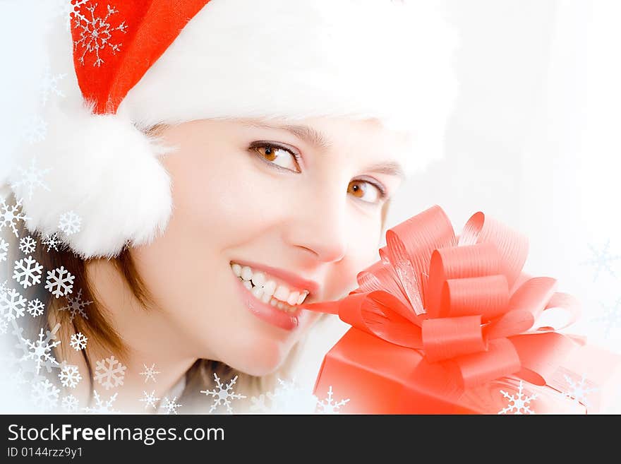 Winter portrait of a smiling woman with a gift