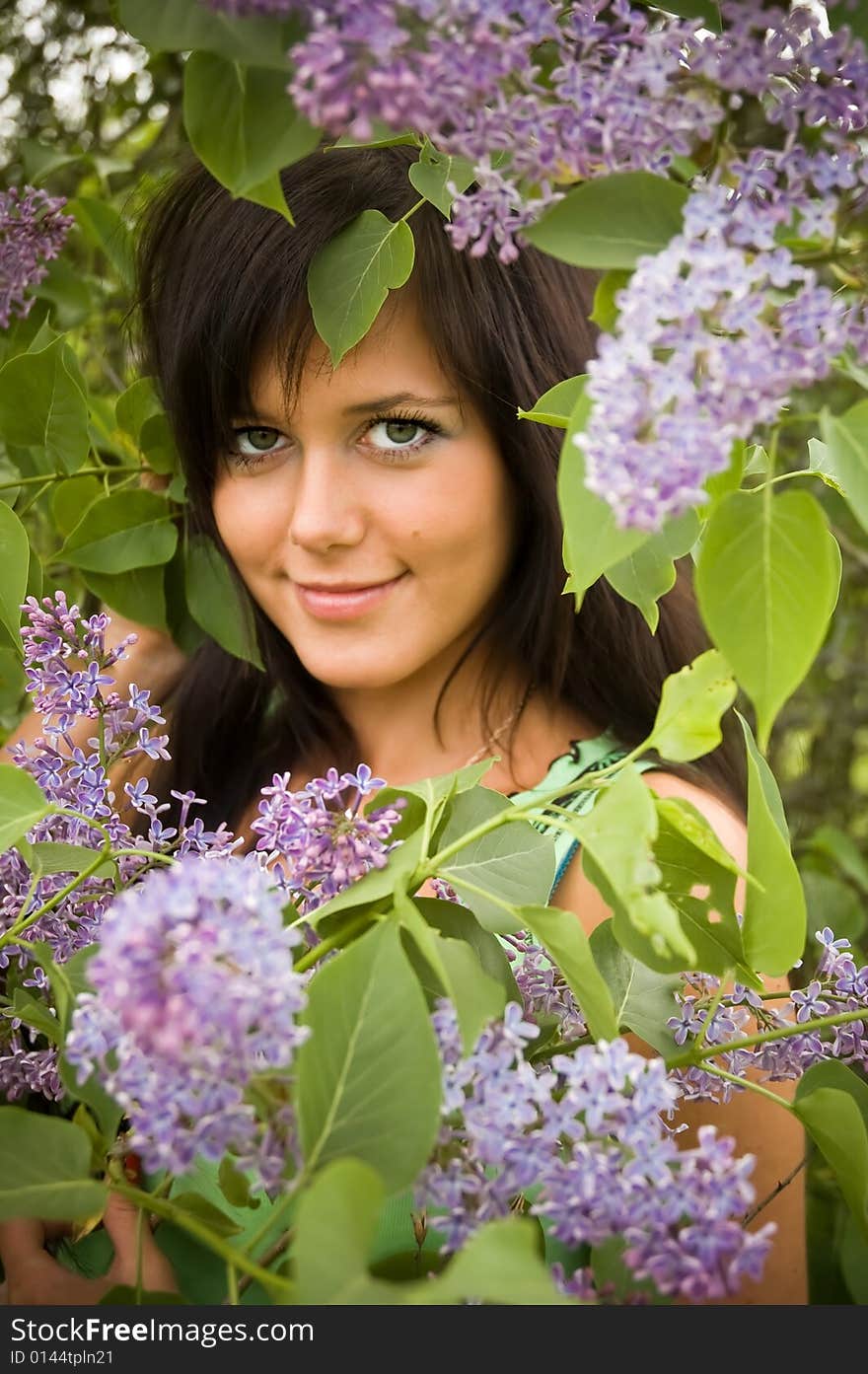 The  girl and blossoming lilac