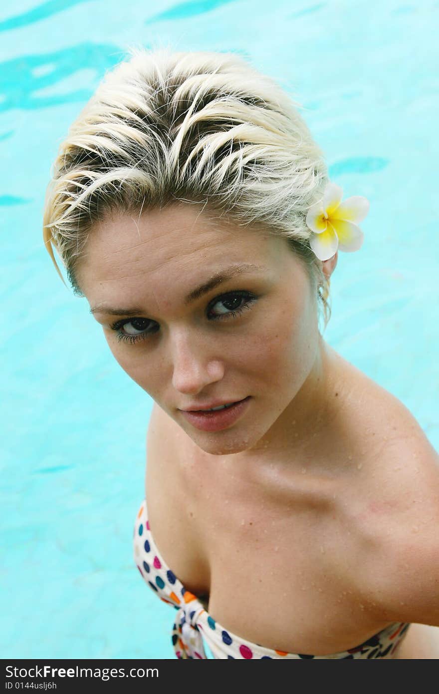 Beautiful blond woman in a swimming pool.