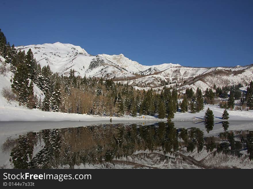 Mountain Lake showing snowy reflections. Mountain Lake showing snowy reflections