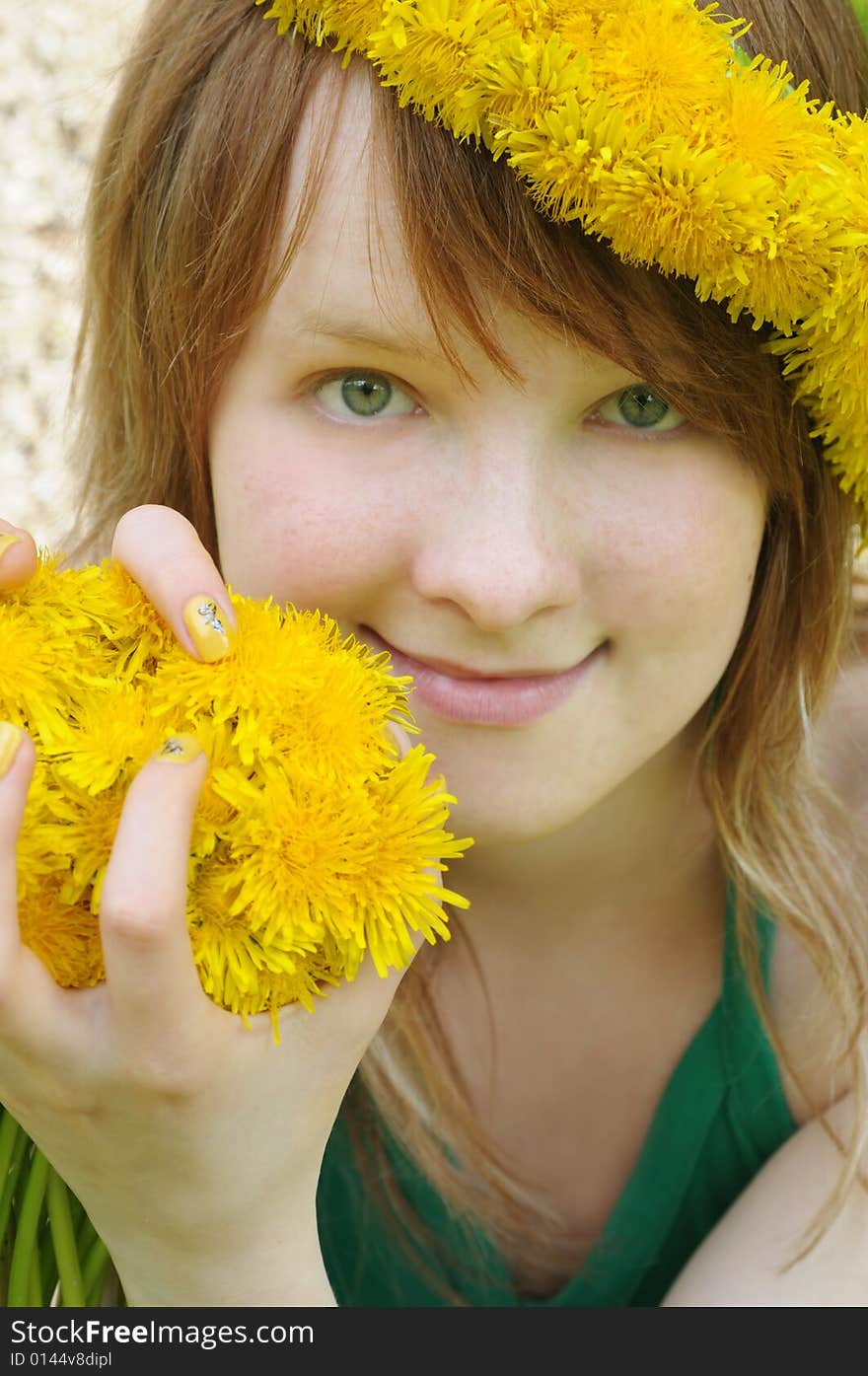 Beautiful girl with red hair and yellow dandelions. Beautiful girl with red hair and yellow dandelions