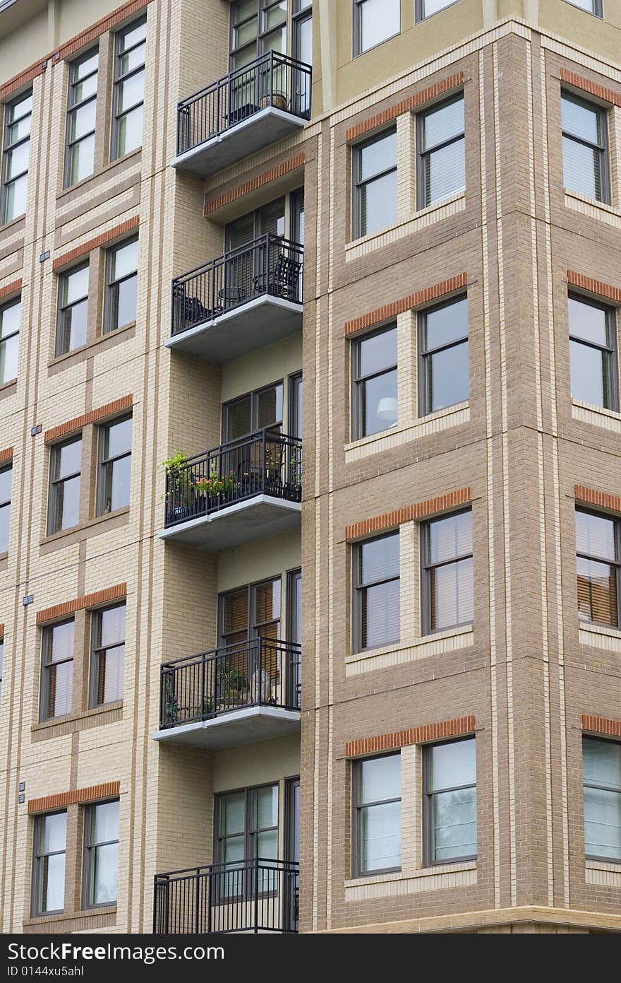 A highrise condo or apartment building with iron balconies. A highrise condo or apartment building with iron balconies