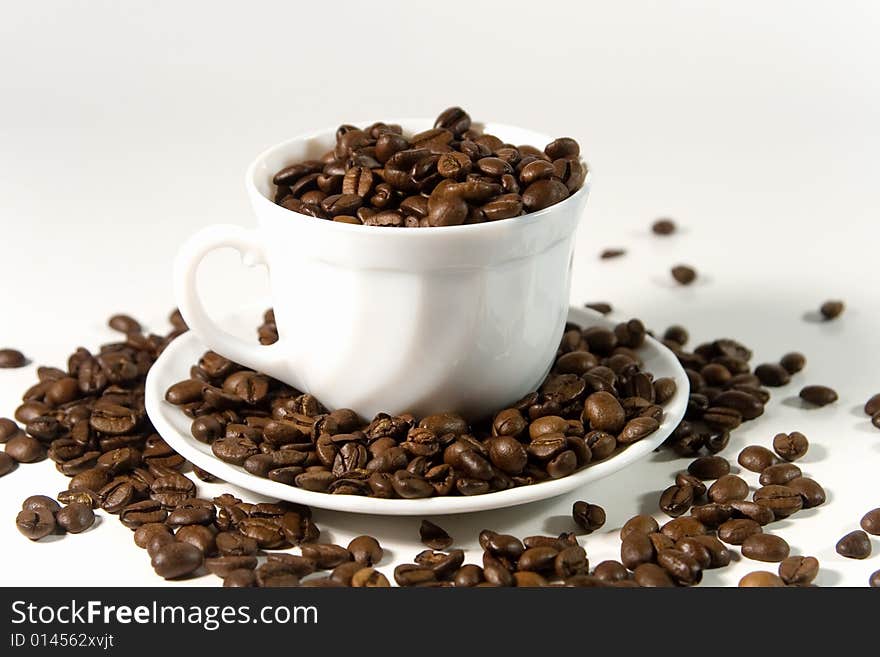 White cup with coffee beans