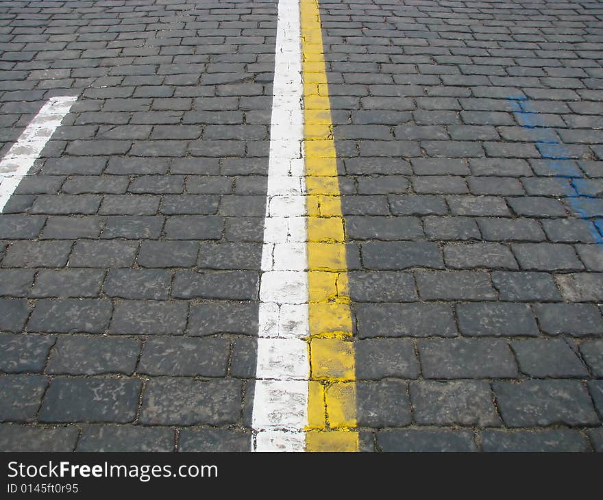 Stone blocks with color lines of a road marking. Stone blocks with color lines of a road marking