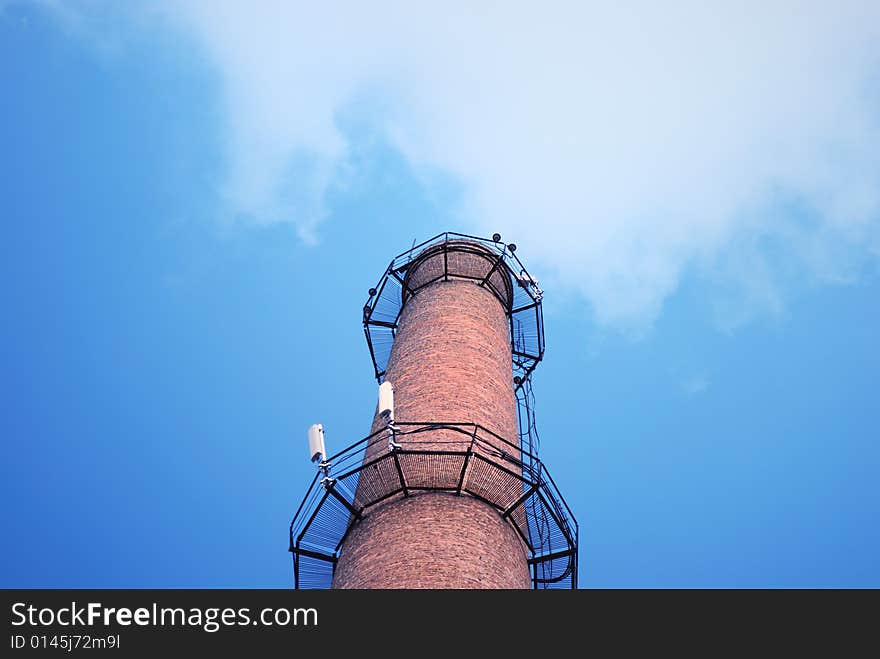 Urban chimney-stalk on a background cloudy sky. Urban chimney-stalk on a background cloudy sky