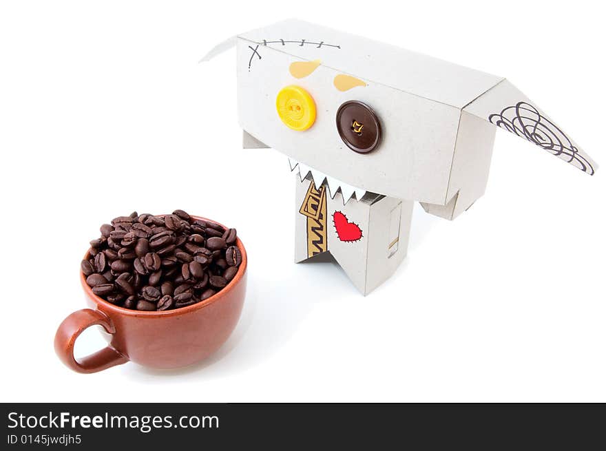 Cardboard toy with expressive face and cup of coffee beans isolated. Cardboard toy with expressive face and cup of coffee beans isolated