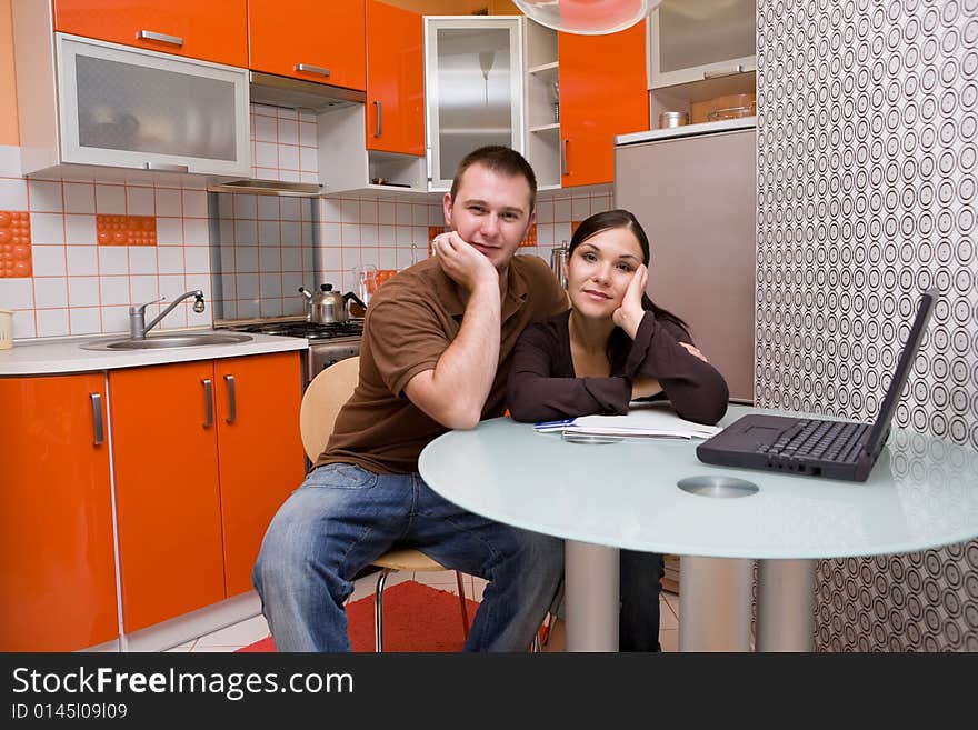 Casual couple happy in their kitchen. Casual couple happy in their kitchen