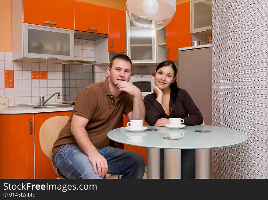 Casual couple happy in their kitchen. Casual couple happy in their kitchen