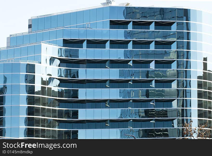 Commercial glass building with highly reflective surface. Commercial glass building with highly reflective surface