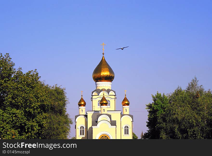 City park, Russian patriarchy, church of sainted Vladimir, sainted place, christian faith, orthodox community, blue sky above gold domes, gold crosses,