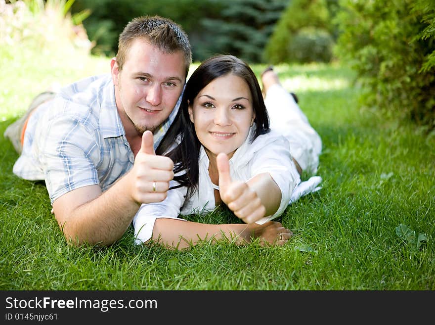 Casual couple lying together on grass. Casual couple lying together on grass