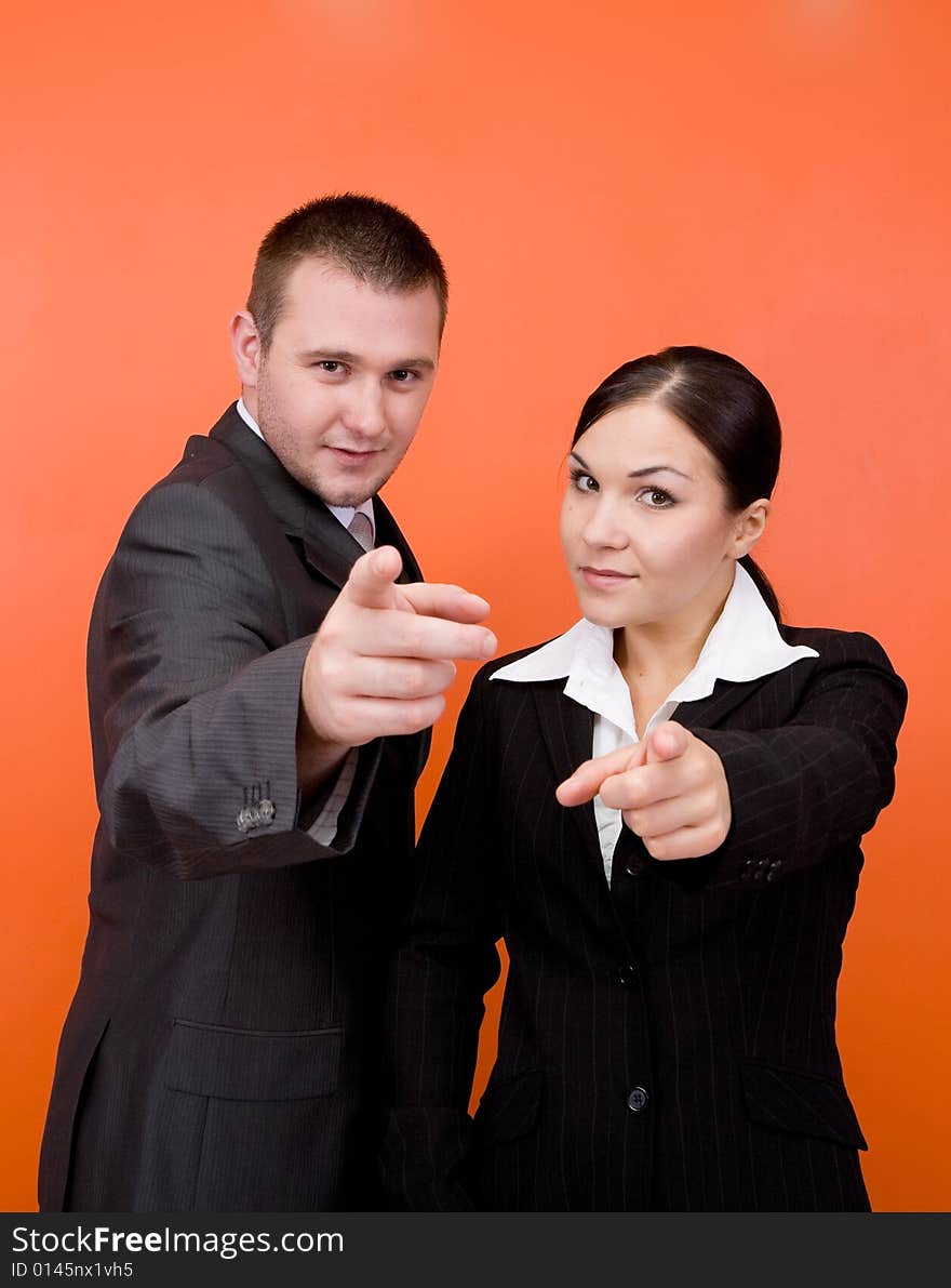 Woman and man in business team standing on orange background