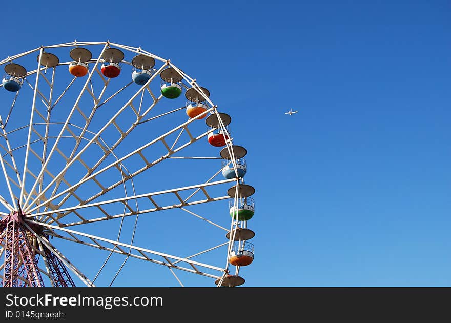 Ferris wheel on background blue sky